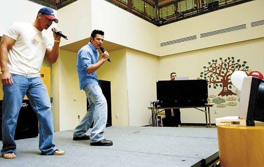John Bialy, left, and Lawrence Gilligan sing "Pour Some Sugar on Me" by Def Leppard in the SUB on Monday during a karaoke event sponsored by ASUNM for Homecoming.