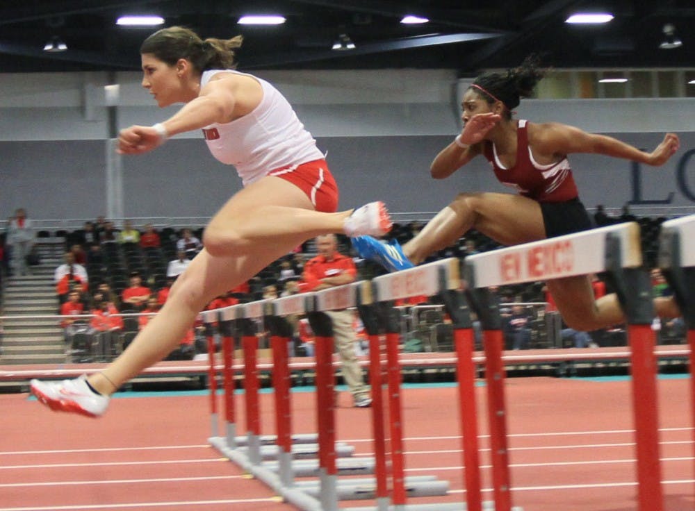 	Sandy Fortner leaps over a hurdle during the final of the 60-meter hurdles in the Lobo Opener on Saturday at the Albuquerque Convention Center. Fortner, who won two events, has overcome injury on her way back to the UNM track-and-field team.