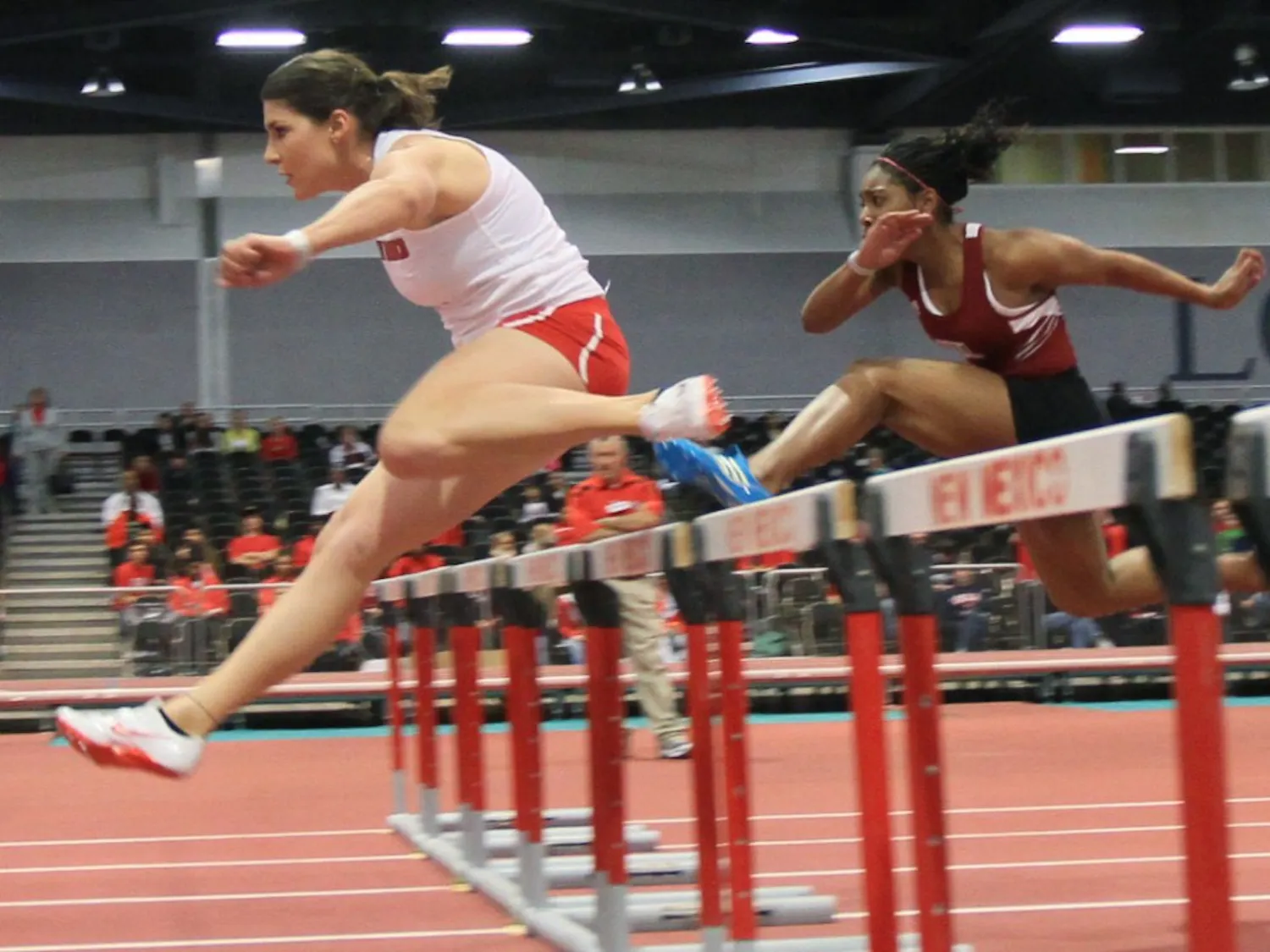 Sandy Fortner leaps over a hurdle during the final of the 60-meter hurdles in the Lobo Opener on Saturday at the Albuquerque Convention Center. Fortner, who won two events, has overcome injury on her way back to the UNM track-and-field team.