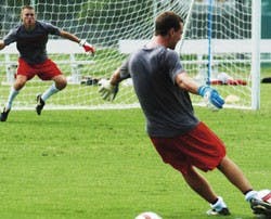 UNM goalkeeper Justin Fite prepares to block a shot from goalie Eric Staver in a drill during practice on Monday at Robertson Field.