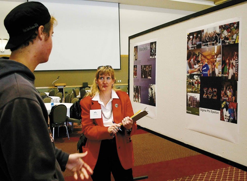 Symposium judge Charlene Porsild, right, talks to Ryan Price about his project on fraternity life in the SUB on Monday. The symposium was a chance for students in Freshman Academic Choices and the Research Service Learning Program to present their work. 