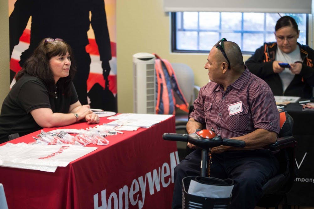 Gilbert Hernandez, an Albuquerque resident, speaks with a Honeywell representative at the New Mexico Center for Development and Disability. Governor Martinez named October as Disability Employment Awareness month and spoke at a 9:30 AM news conference preceding a job fair at the CDD. 