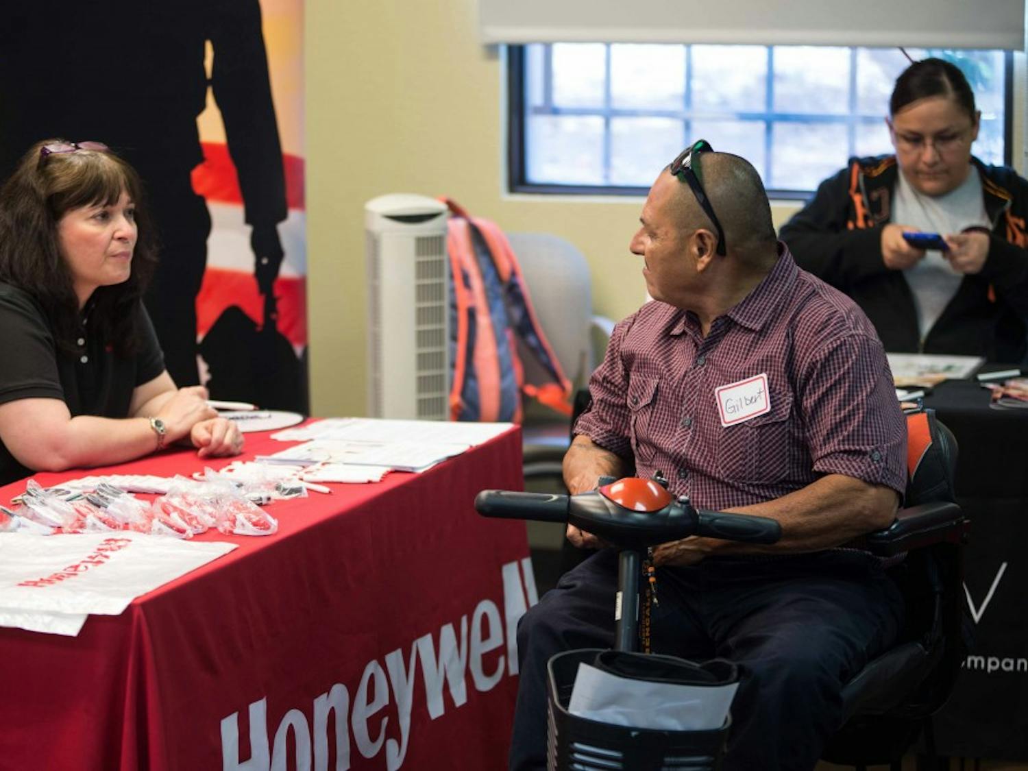 Gilbert Hernandez, an Albuquerque resident, speaks with a Honeywell representative at the New Mexico Center for Development and Disability. Governor Martinez named October as Disability Employment Awareness month and spoke at a 9:30 AM news conference preceding a job fair at the CDD. 