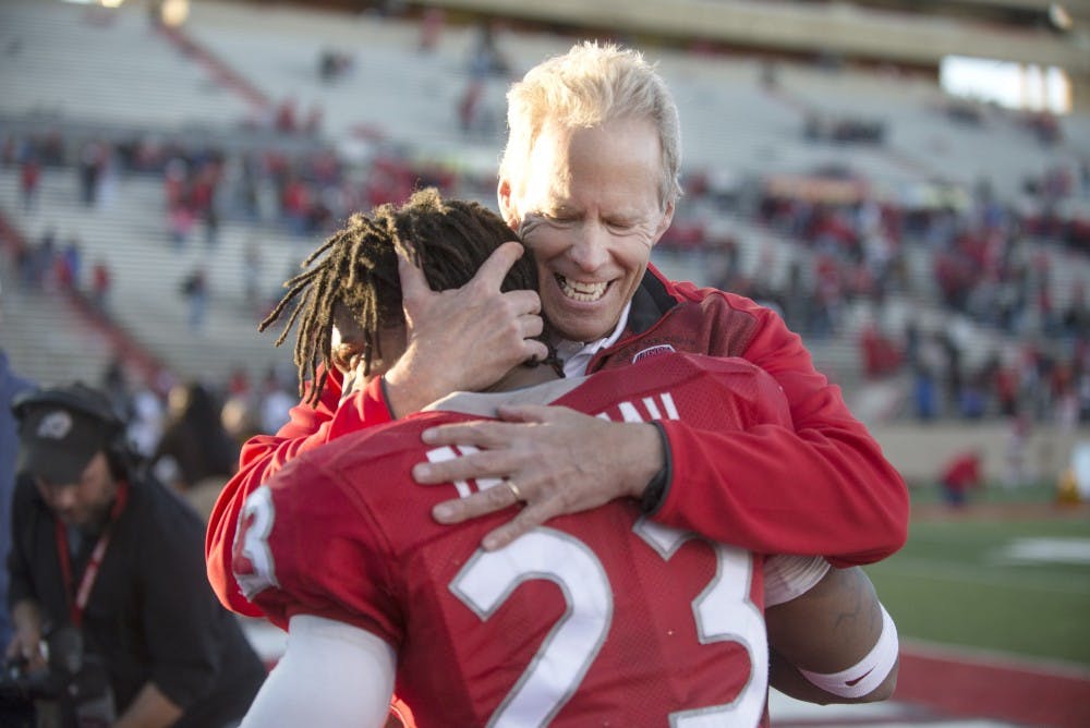 New Mexico football head coach Bob Davie embraces senior safety Devonta Tabannah after the final home game against Wyoming on Saturday. The Lobos defeated the Cowboys 36-30, its first home victory of the season.