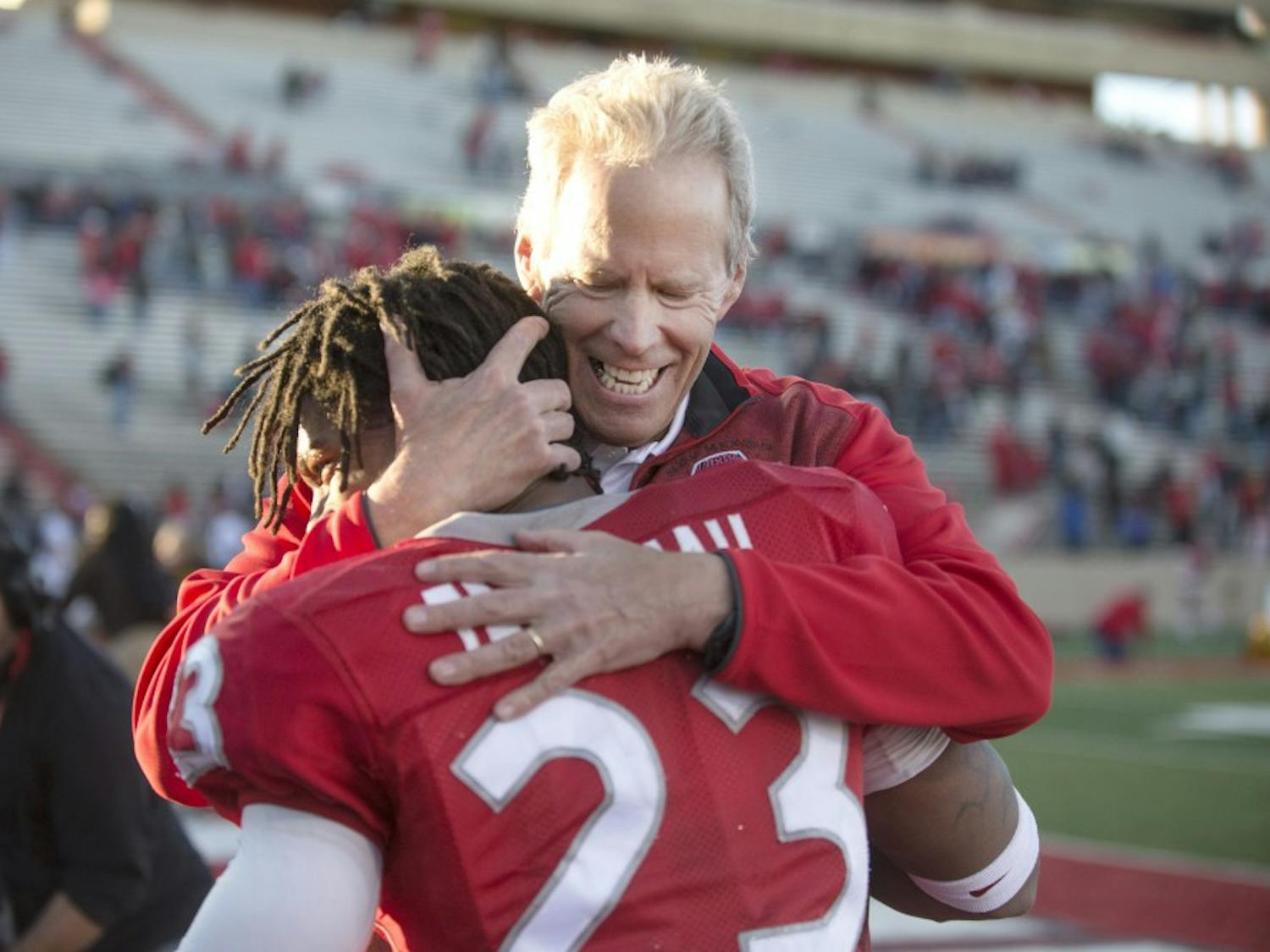 New Mexico football head coach Bob Davie embraces senior safety Devonta Tabannah after the final home game against Wyoming on Saturday. The Lobos defeated the Cowboys 36-30, its first home victory of the season.
