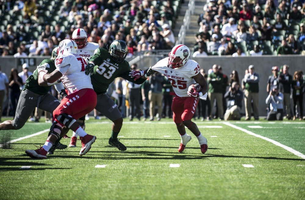 Tyrone Owens attempts to get away from CSU linebacker&nbsp;Caleb Smith during the first half of Saturday's game at Canvas Stadium in Fort Collins, CO. The Lobos lost 20-18 on a last second field goal.