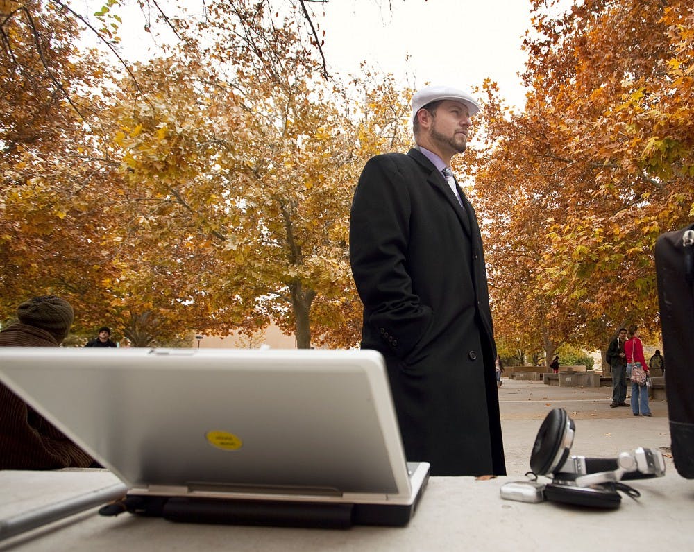 	Joshua “Techno Guy” Arellano listens to music playing on his laptop Thursday at the north end of the SUB. Arellano used to play techno music on his boom box every Tuesday and Thursday, but since professor James Burbank filed a complaint against Arellano, he plays his laptop to keep the volume down.
