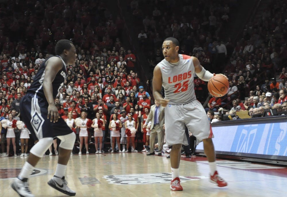 New Mexico guard Tim Jacobs works the ball against a Utah State defender during their Mountain West showdown on Feb. 7. The Lobos look to end a six-game losing streak tonight at Boise State.
