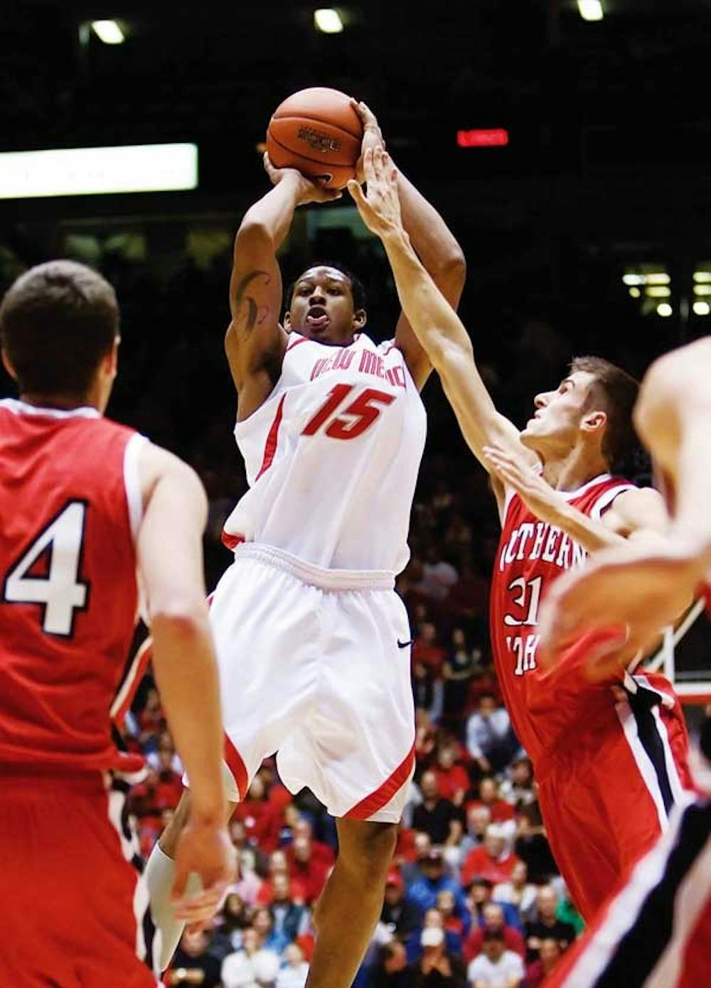 UNM's J.R. Giddens shoots while Southern Utah's Rick Roberts tries to block during Wednesday's game at The Pit.