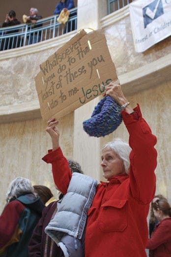 Mary Burton Riseley, from Cliff, N.M., displays a sign protesting the death penalty. Riseley was one of more than 100 people who rallied in Santa Fe on Monday in support of a bill that would abolish the death penalty.