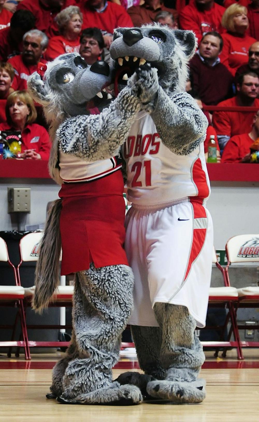 	In this Jan. 27 file photo, Louie and Lucy Lobo waltz while Lucy eyes a husky sitting courtside.
