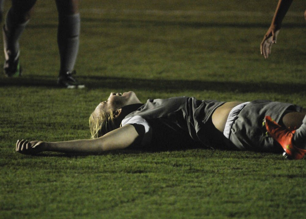 Lobo redshirt freshman forward Quincy Slora lies on the ground after scoring a goal during the second half of the soccer game against Loyola-Chicago at UNM Soccer Complex on Friday night. The Lobos won 4-2.