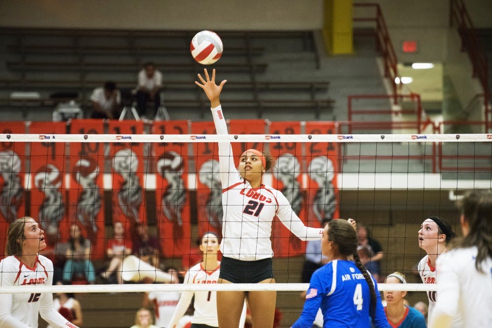 Mariessa Carrasco attempts to dink the ball over the net against