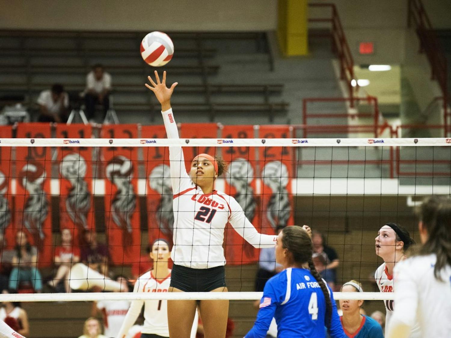 Mariessa Carrasco attempts to dink the ball over the net against