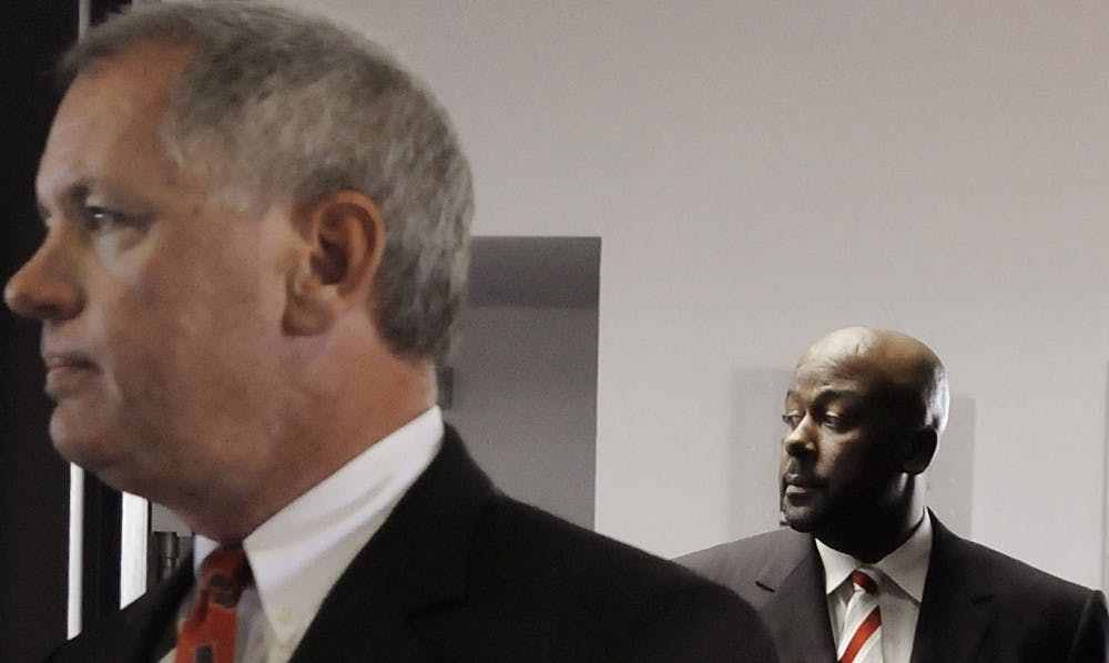 	Athletics Director Paul Krebs, left, and head football coach Mike Locksley arrive at the Tow Diehm Facility for a press conference Tuesday. Krebs announced that Locksley is on a 10-day suspension after the Sept. 20 physical altercation involving Locksley and wide receivers coach J.B. Gerald.