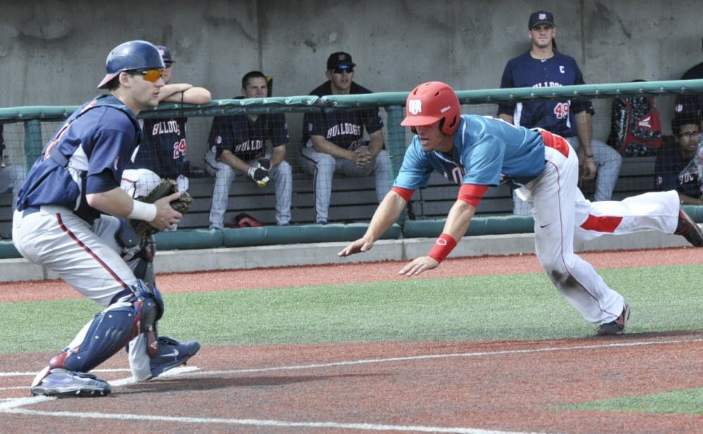 Junior infielder Dalton Bowers jumps into home plate during Sundays game against Fresno State. The Lobos won 5-1.
