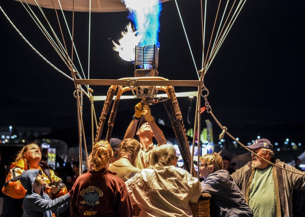 A hot air balloon pilot and his crew light up the night at the Oct. 9, 2017 Balloon Glow during the Albuquerque International Balloon Fiesta.