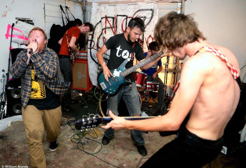 Members of the band Crushed!?, play at a house venue called the Fly Honey Warehouse. Crushed!? is a five-piece post-hardcore band.