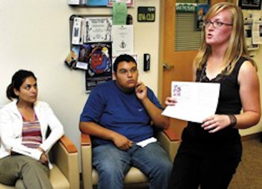 Layla Mohagheghi, left, and David Medrano listen to Megan Fitzpatrick, president and founder of the International Medical Delegation at UNM, in the Lobo Lair in the basement of the SUB on Friday.