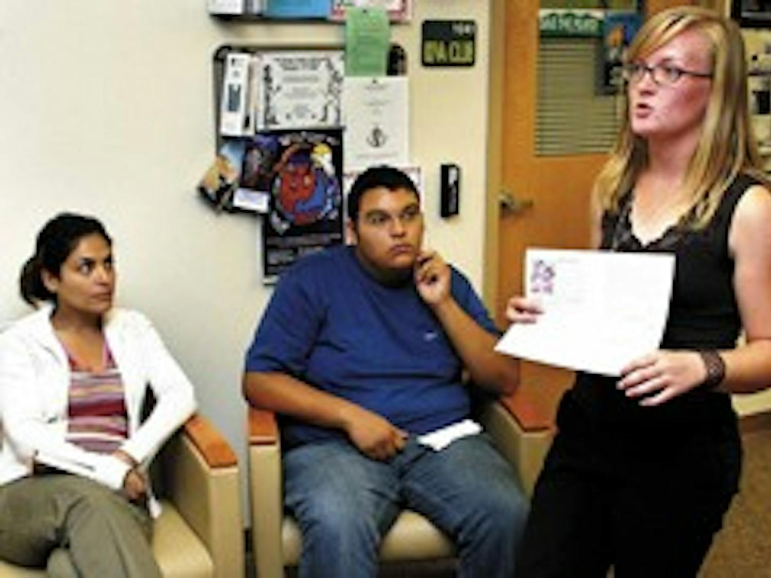 Layla Mohagheghi, left, and David Medrano listen to Megan Fitzpatrick, president and founder of the International Medical Delegation at UNM, in the Lobo Lair in the basement of the SUB on Friday.