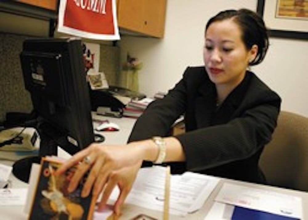 Student Regent Rosalyn Nguyen looks through paperwork in her office in the SUB after classes on Thursday.