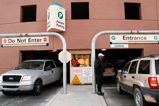 Fred Brown greets people at the UNM Hospital parking structure on Tuesday. Car thefts in the University area have increased this year, according to UNMPD. 