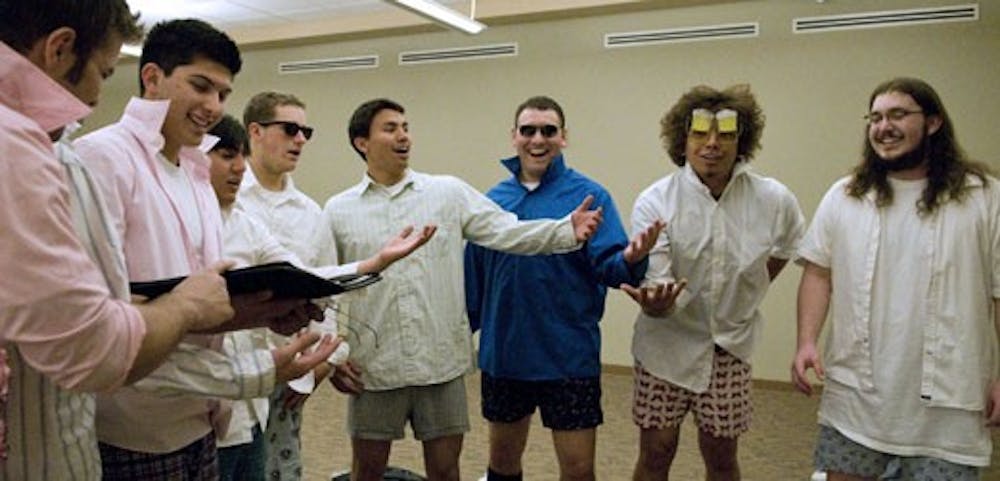 UNM fraternity members practice serenading in the SUB on Monday. Pledges used the power of song to introduce themselves to campus sororities.