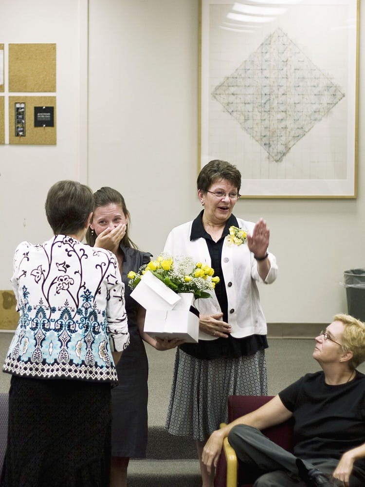 	Emily Hunt, second from left, cries after receiving the Phyllis Wilcox Scholarship on Thursday. Mrs. Wilcox, far left, presented the linguistics department award at the Humanities Building.