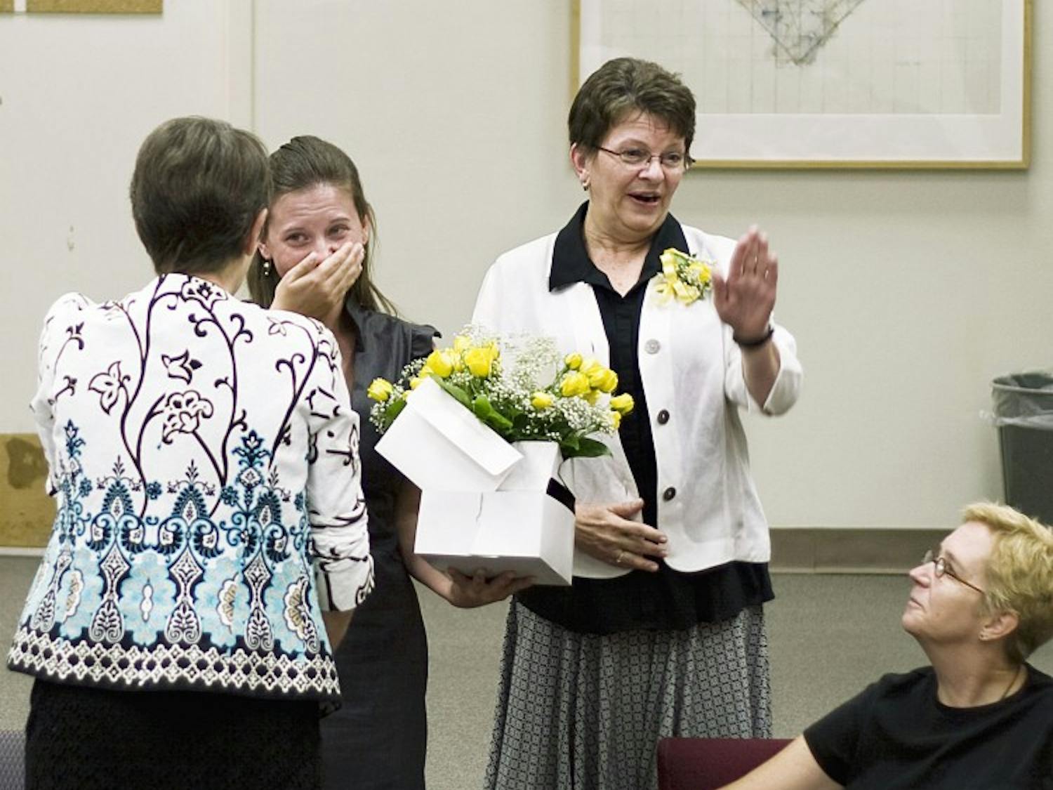 Emily Hunt, second from left, cries after receiving the Phyllis Wilcox Scholarship on Thursday. Mrs. Wilcox, far left, presented the linguistics department award at the Humanities Building.