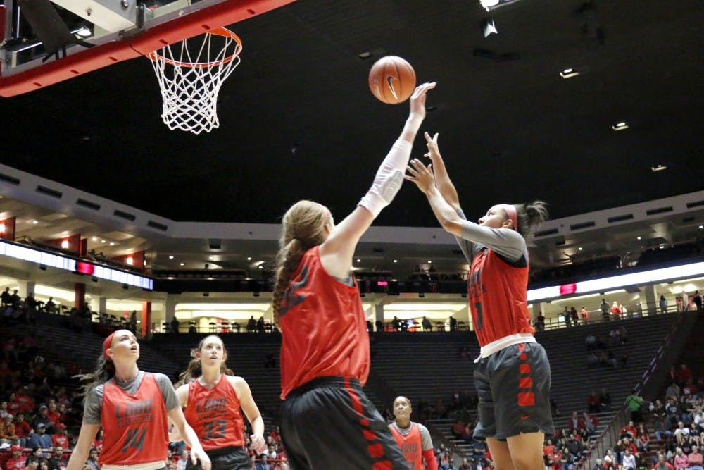 Guard Cherise Beynon reaches for a shot while forward Kianna Keller tries to block her during the Lobo Howl on Oct. 16. The Lobos have their first exhibition on Nov. 4 against Western New Mexico.