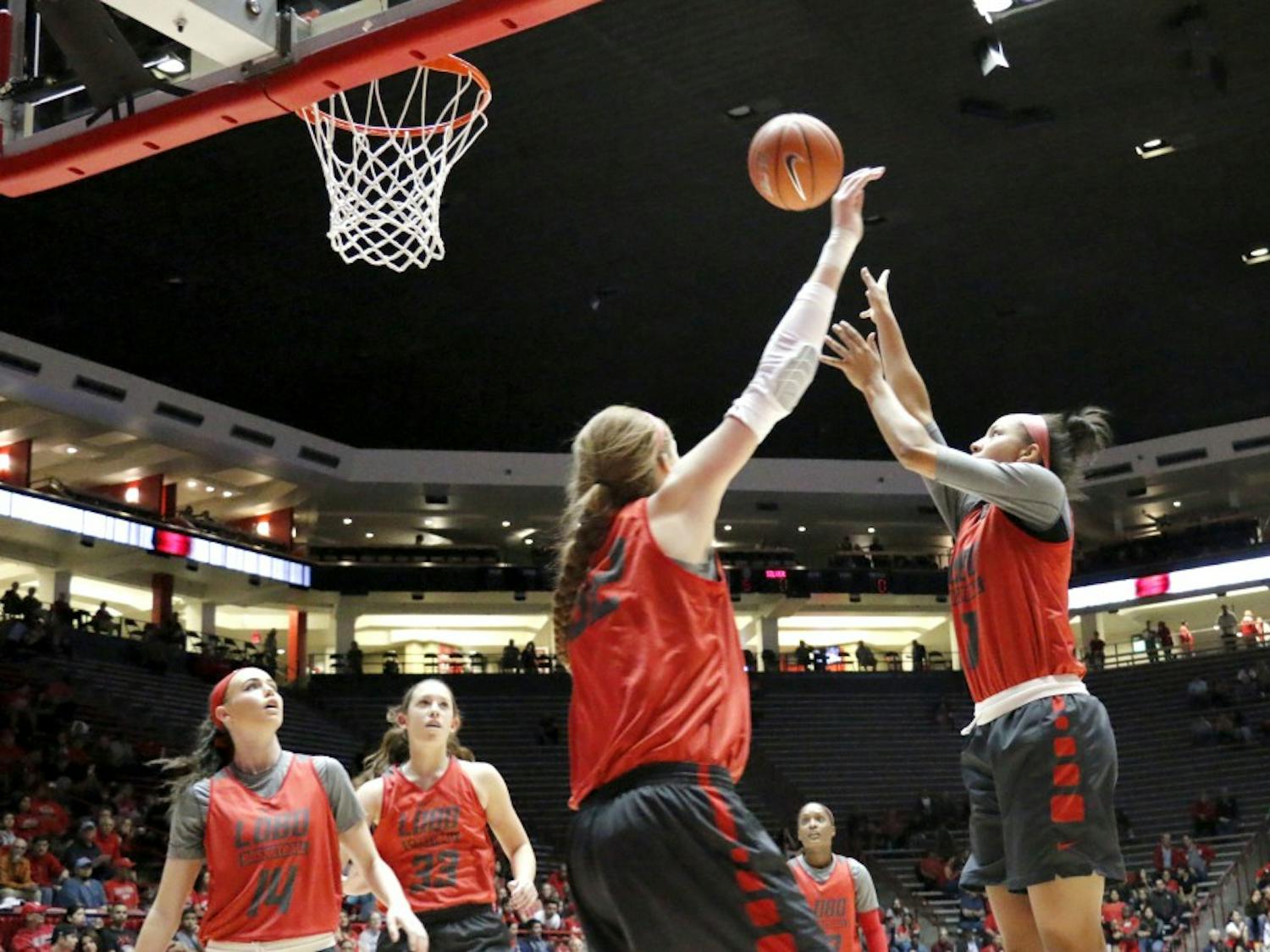 Guard Cherise Beynon reaches for a shot while forward Kianna Keller tries to block her during the Lobo Howl on Oct. 16. The Lobos have their first exhibition on Nov. 4 against Western New Mexico.