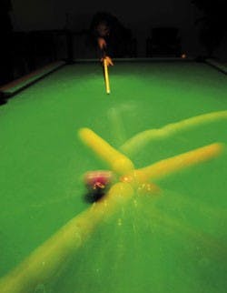 Student Kirbie Seis breaks at the beginning of a game of nine-ball Monday at the game room in the SUB. NMPIRG's student chapter and ASUNM's Community Experience held a nine-ball tournament and donated the proceeds to local homeless shelters.  