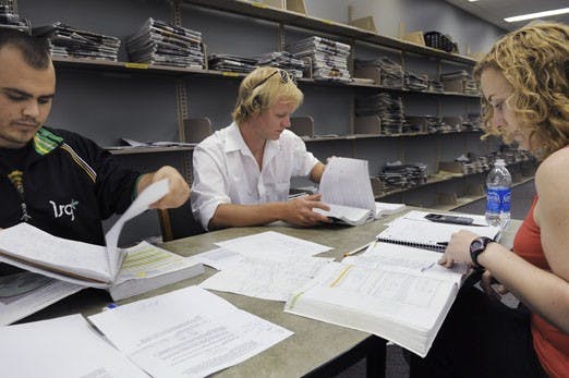 Nick Martinez, left, Mason Preusser, center, and Celeste Fischer study for finals at Zimmerman Library on Tuesday. "Man, this sucks. Worst week of school," Preusser said.