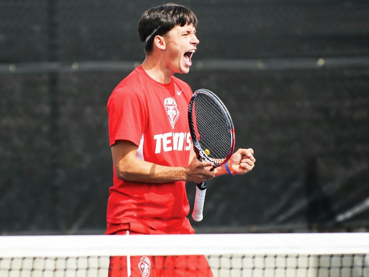 Freshman Ricky Hernandez-Tong celebrates after scoring a point against Air Force Saturday afternoon at the McKinnon Family Tennis Stadium. The Lobos swept both BYU and Air Force this past weekend in Albuquerque.