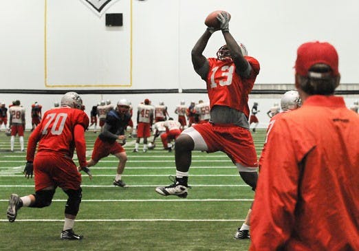 Tailback James Wright snares a high pass at practice Wednesday. UNM will need a win in Las Vegas against UNLV to preserve its bowl chances. 