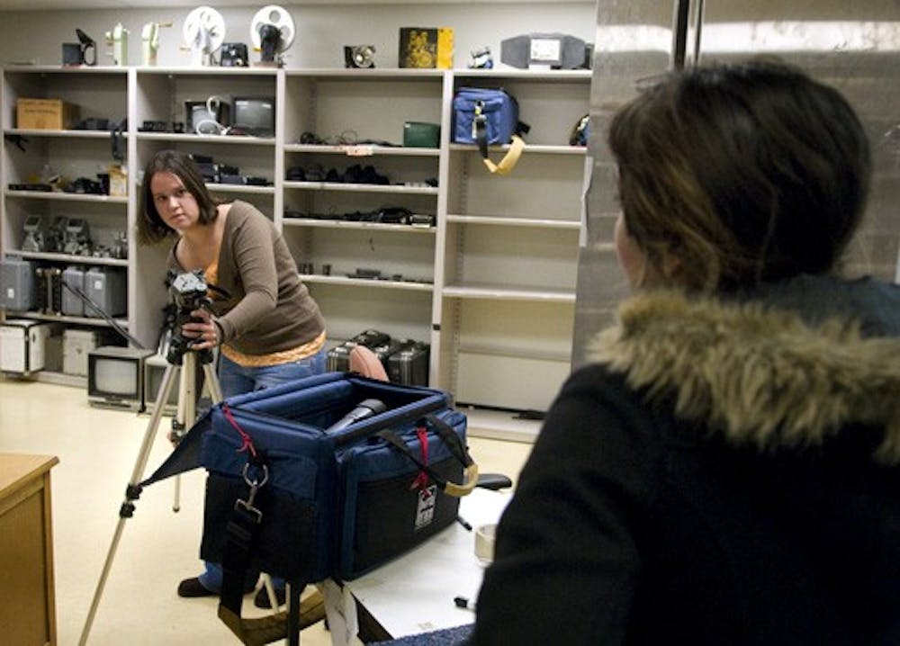 Alicia Garcia, left, assists Elana Schwartz with video equipment from the Media Arts equipment cage. Secretary of State Mary Herrera is sponsoring a contest asking students to make a public service announcement encouraging people with disabilities to vote