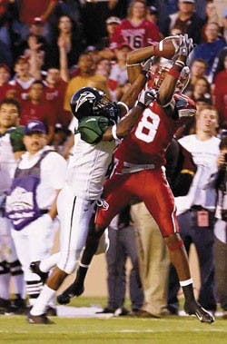 UNM wide receiver Daryl Jones, right, makes a reception against Portland State's Jordan Senn during the first quarter Saturday at University Stadium. 