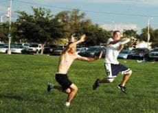 UNM students Josh Tybur, left, and Travis Johnson play Frisbee football at Johnson Field.