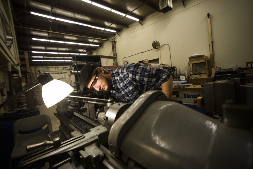 Joshua Pedersen prepares a lathe to craft the hilt to one of his battle sabers. Pedersen handmakes every aspect of his sabers from scratch.&nbsp;