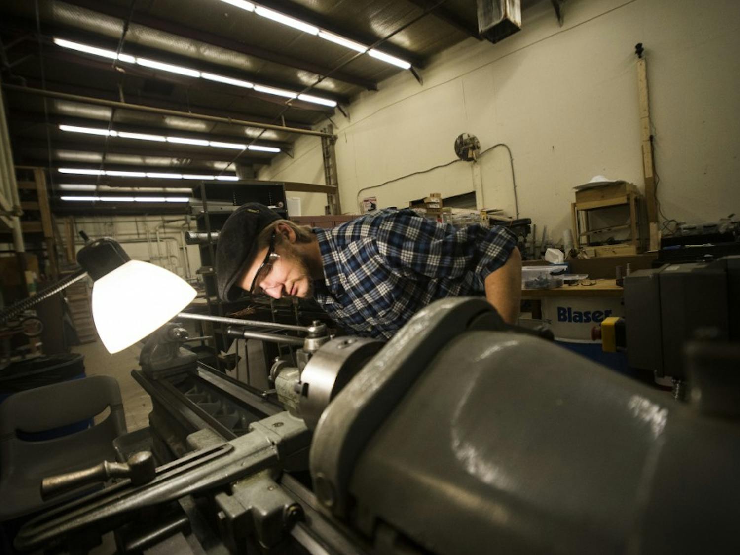 Joshua Pedersen prepares a lathe to craft the hilt to one of his battle sabers. Pedersen handmakes every aspect of his sabers from scratch. 