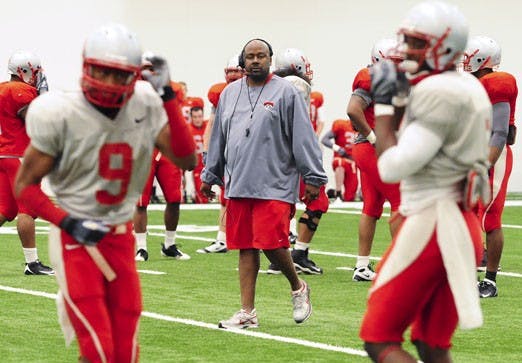 Head football coach Mike Locksley, center, recently instituted a policy that prohibits his players from going to bars in Downtown Albuquerque after hours since two UNM players were arrested in the area last week.
