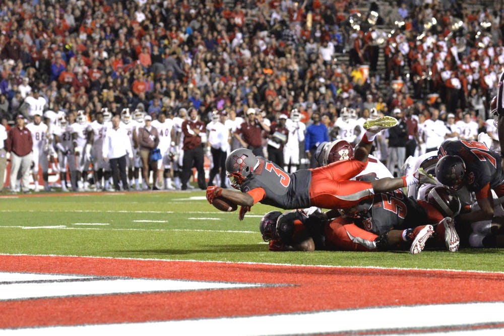 Lobo running back Richard McQuarley dives into the end zone during their game against NMSU Saturday Oct. 3, 2015. UNM beat out NMSU 38-29 and play Oct. 10 in Reno. 