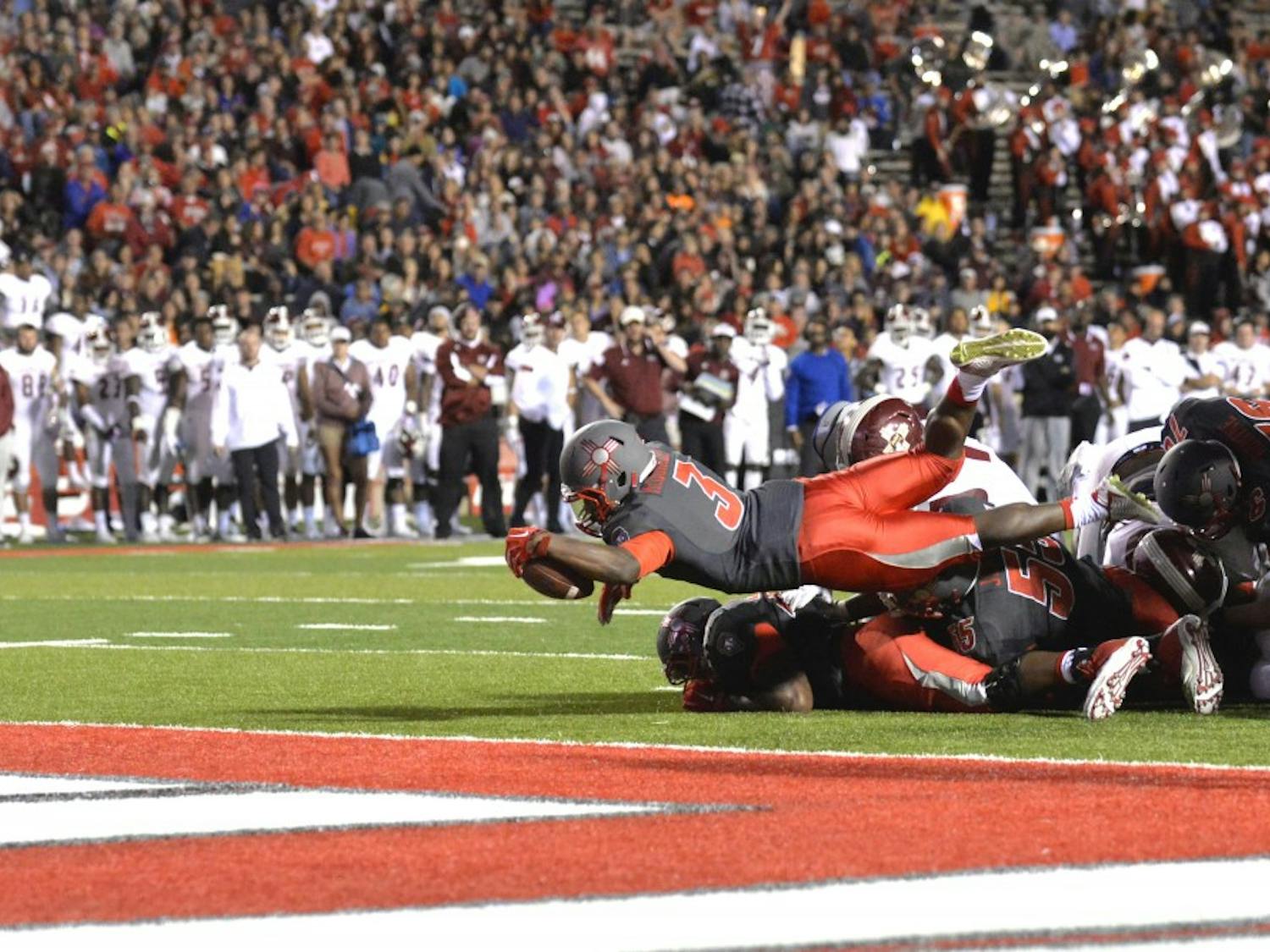 Lobo running back Richard McQuarley dives into the end zone during their game against NMSU Saturday Oct. 3, 2015. UNM beat out NMSU 38-29 and play Oct. 10 in Reno. 