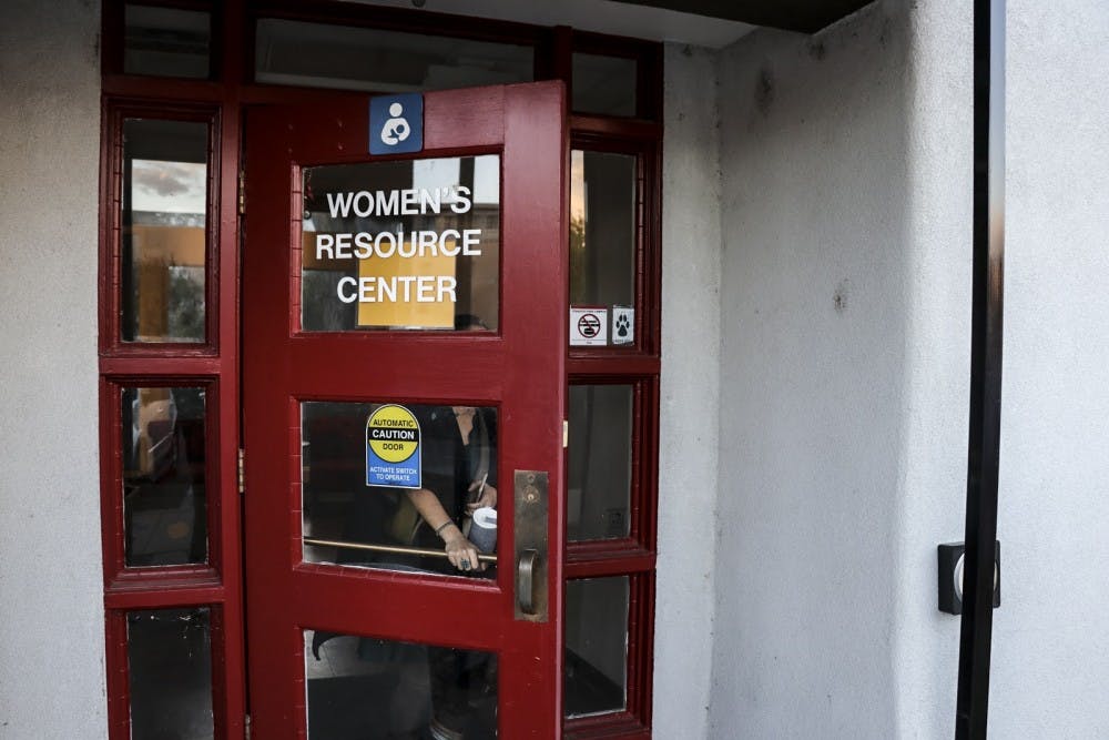 A woman walks out of the Women's Resource Center on the evening of Oct. 24, 2018.