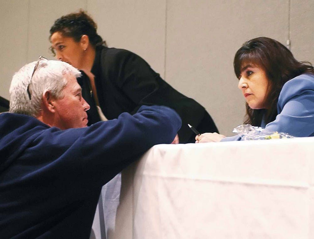 Panel guest Loretta Naranjo-Lopez speaks to Timothy Flynn after a lunch meeting during Gov. Bill Richardson's Faith-based and Community Initiatives Conference on Thursday in the SUB.