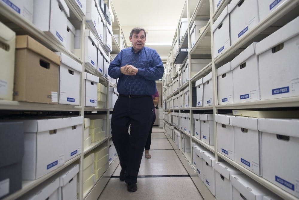 	Michael Kelly, director of the Southwest Research Center, walks through the aisles of rare books, photographs, manuscripts and blueprints inside Zimmerman Library on Aug. 27. The main purpose of the Southwest Research Center is to make the more than one million rare items and materials available to students and researchers throughout the world.