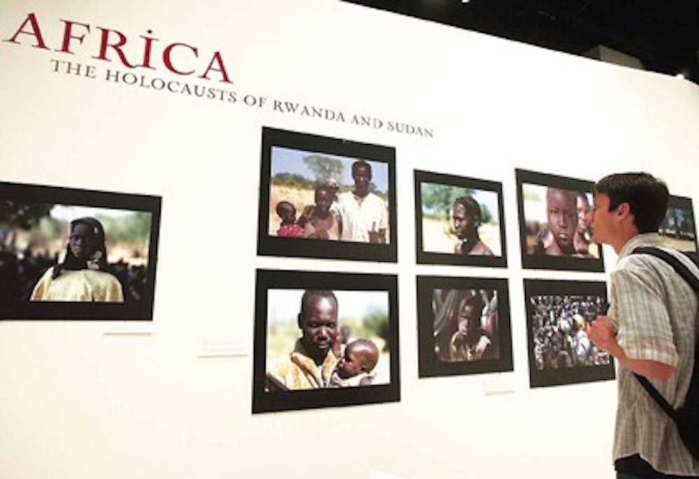 UNM student Tim Dempsey looks at an exhibit on genocide in Africa on April 18 at the Maxwell Museum.