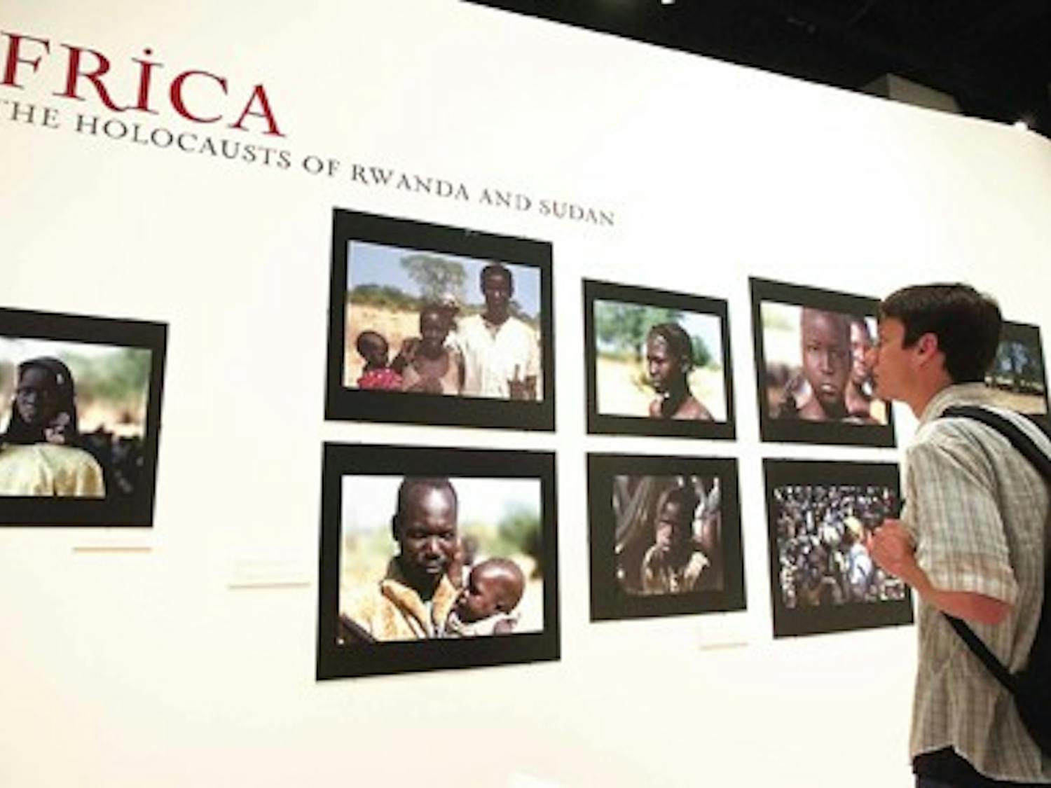 UNM student Tim Dempsey looks at an exhibit on genocide in Africa on April 18 at the Maxwell Museum.