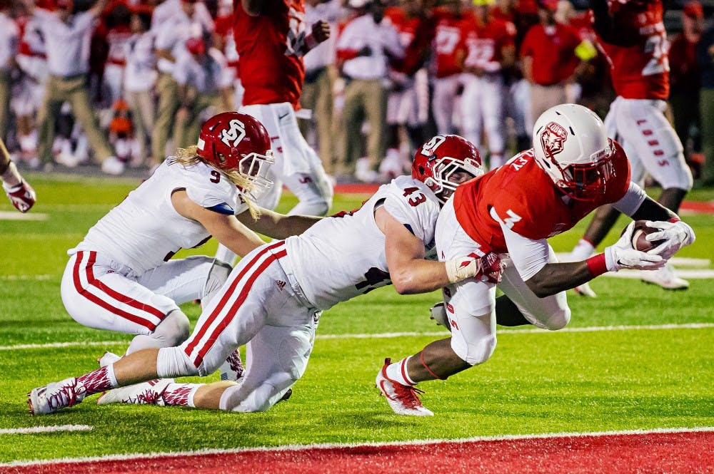 Junior running back Richard McQuarley dives into the Lobo end zone during the team’s game against South Dakota on Thursday, Sept. 1, 2016 at University Stadium.