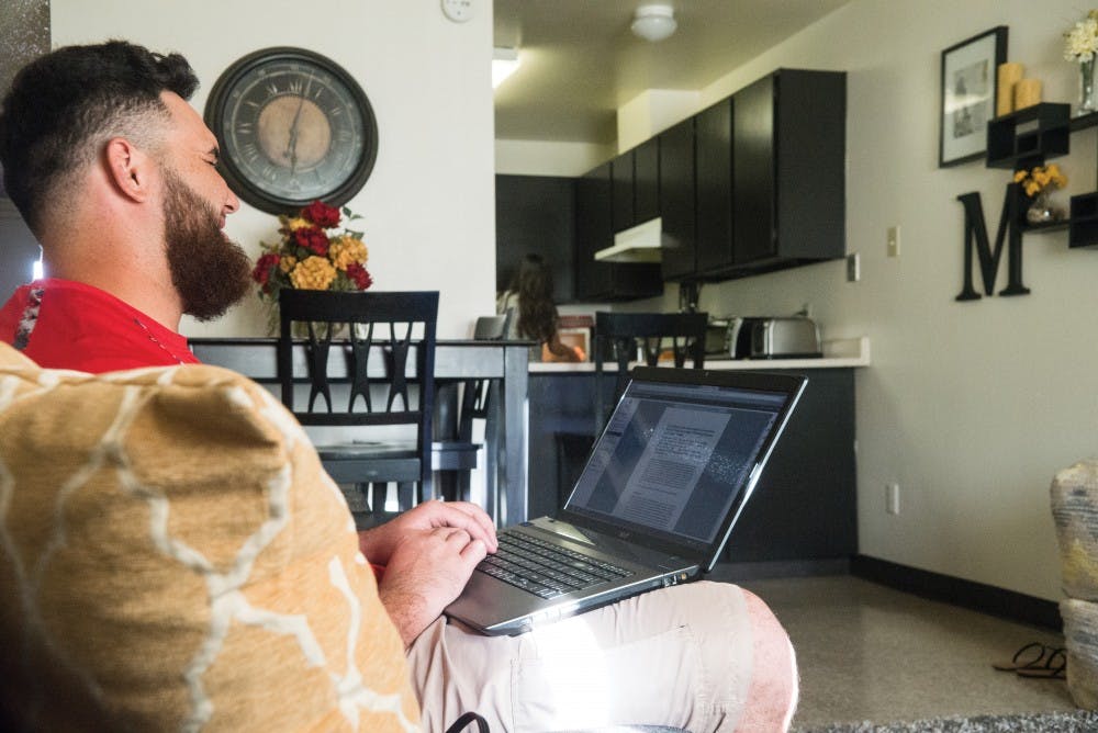 Lobos defensive lineman Eden Mahina laughs as he and his wife spend time together cooking dinner on Wednesday afternoon. Mahina and his wife, Candice, are expecting their first child in the next months.